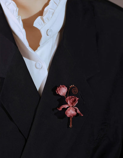 Handmade velvet flower brooch worn on a tailored suit lapel, showcasing elegant Chinese ronghua craftsmanship