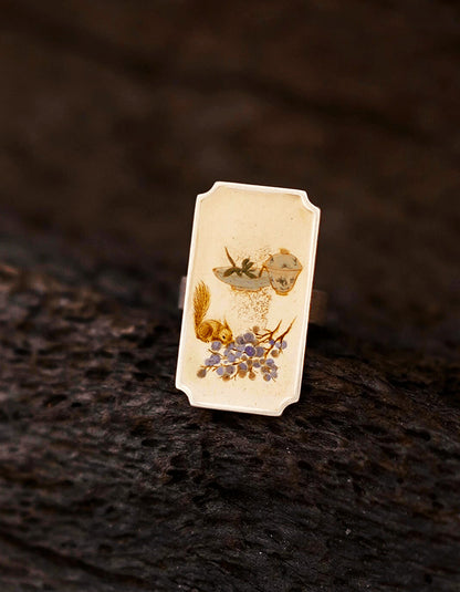 Detailed view of Chinese lacquer ring featuring miniature painting, lacquer finish, and silver setting