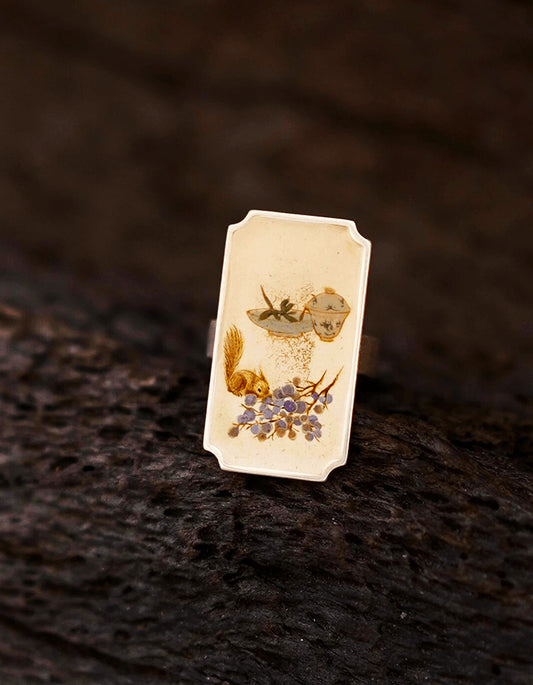 Detailed view of Chinese lacquer ring featuring miniature painting, lacquer finish, and silver setting