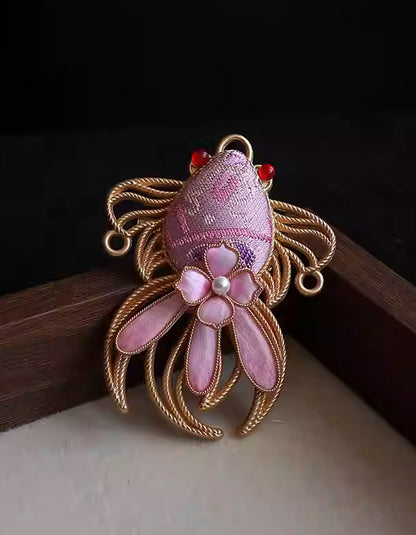 Handcrafted pink koi fish brooch in Song brocade with gold wire detailing and pearl center