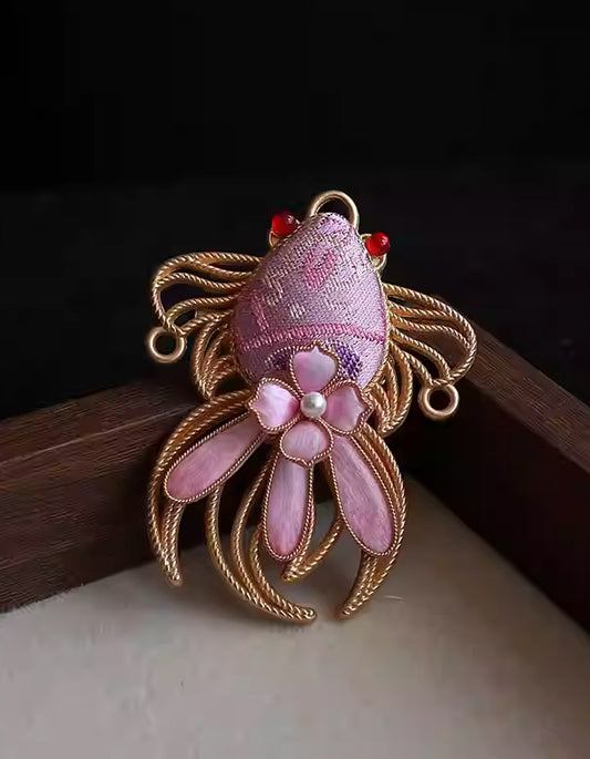 Handcrafted pink koi fish brooch in Song brocade with gold wire detailing and pearl center