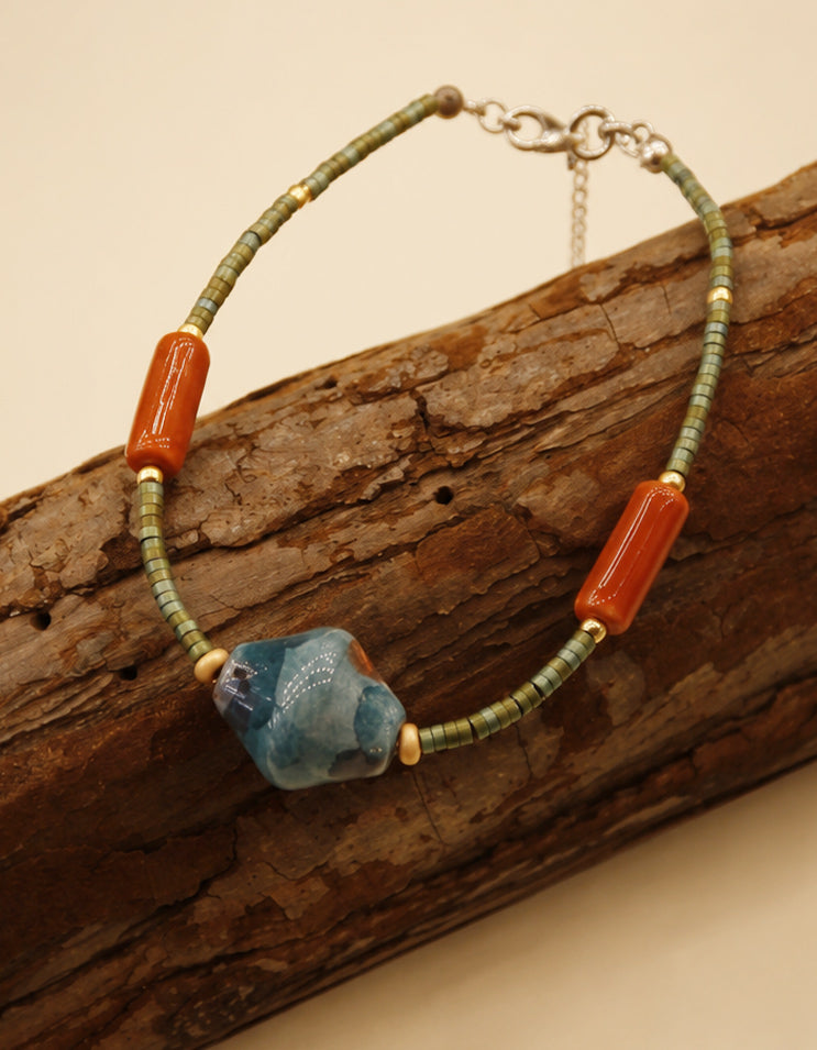 Handcrafted ceramic bracelet by ZolanJewelry featuring enamel detailing and fine artisan craftsmanship inspired by Chinese art techniques.