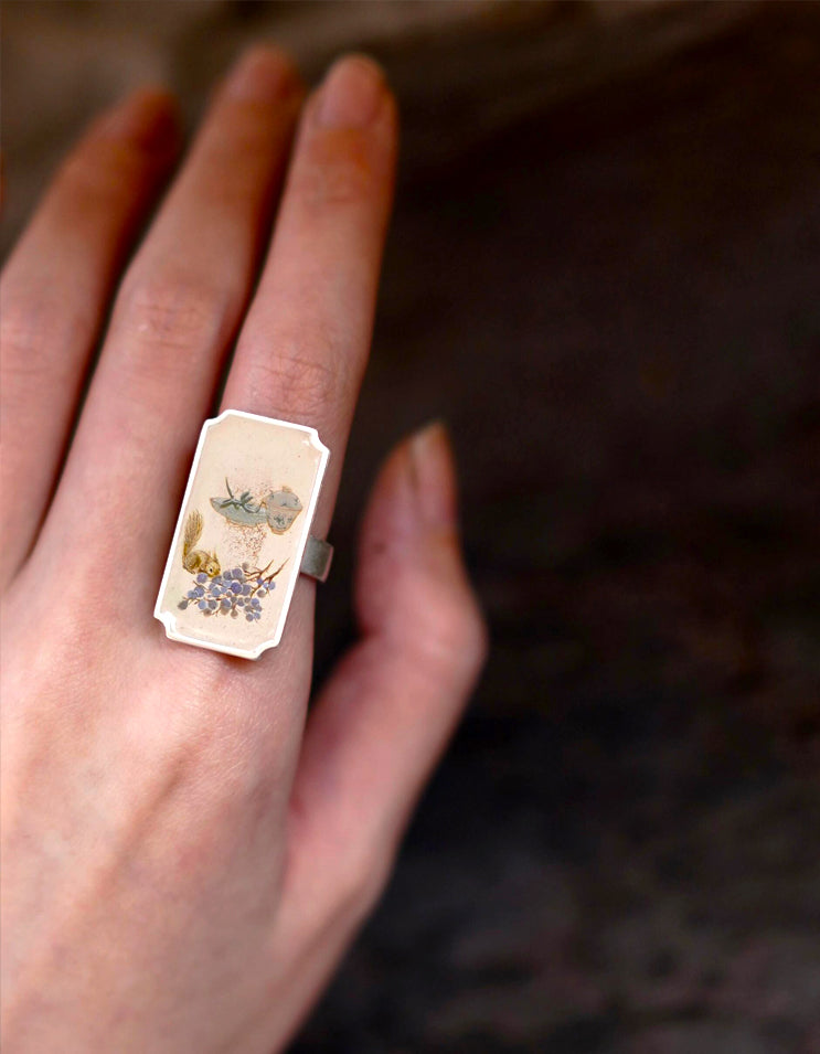 A wearable miniature painting. Woven with genuine 8,000-year heritage Chinese lacquer and fine silver.