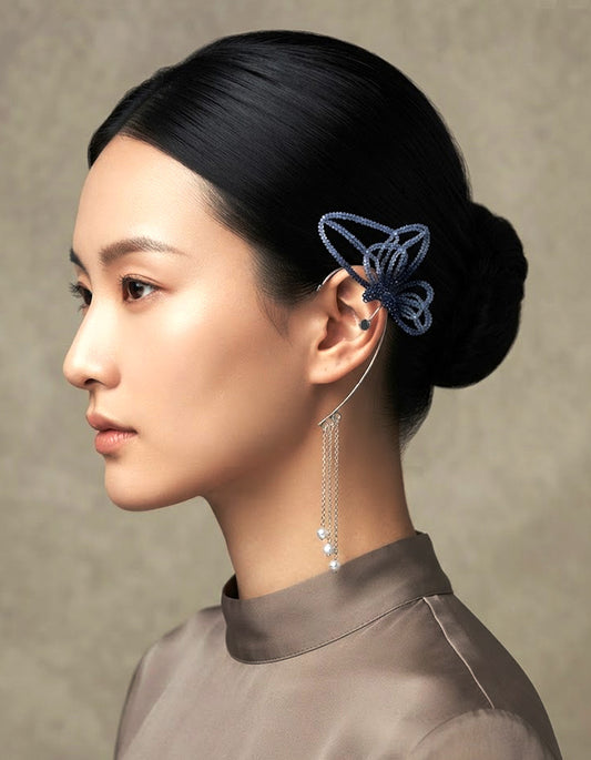 A woman wearing Zolan Jewelry Azure Dream Clip-On Celadon Butterfly Ear Cuff