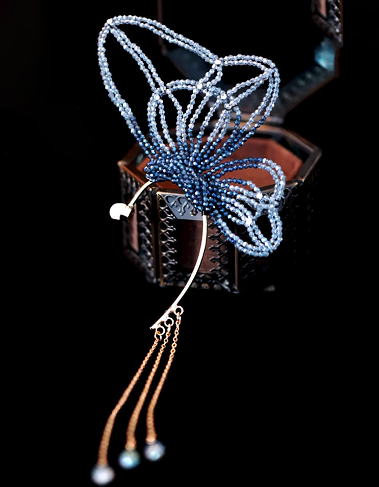 Inspired by Zhuangzi's butterfly dream, this clip-on ear cuff captures flight without piercings. Beaded wings in celadon tones shimmer like poetry