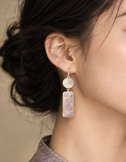 Model wearing Zolanjewelry Fluid Mirage Song Brocade Tassel Earrings showcasing traditional Chinese Song Brocade craftsmanship