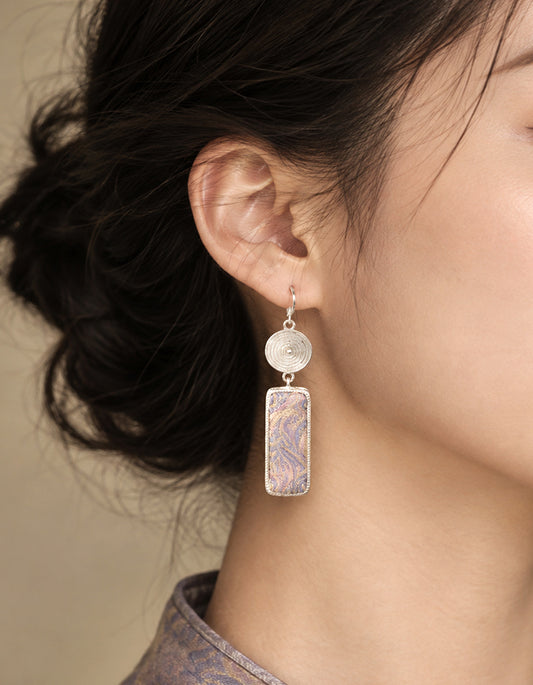 Model wearing Zolanjewelry Fluid Mirage Song Brocade Tassel Earrings showcasing traditional Chinese Song Brocade craftsmanship