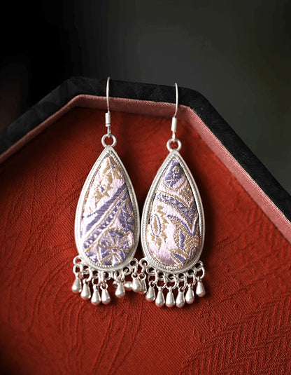 Inspired by Song Dynasty ink rainscapes, these teardrop earrings pair gradient indigo brocade with engraved silver, echoing Jiangnan's poetic mist.