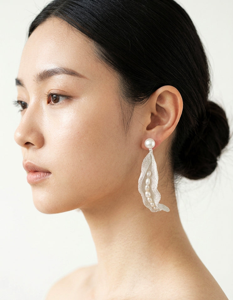 Model wearing Zolanjewelry Silk Pod Mesh Freshwater Pearl Earrings