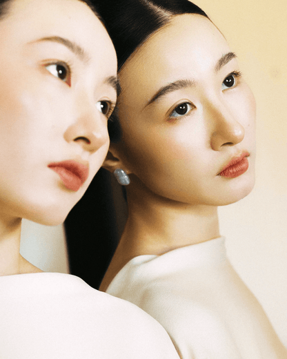 Side view of earrings styled for evening event, baroque pearls glowing under soft lighting