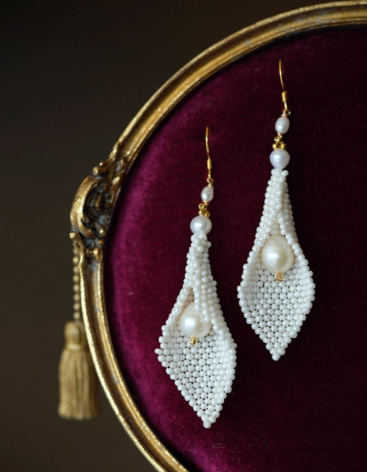 Detailed view of ZolanJewelry calla lily pearl earrings showing delicate handwoven craftsmanship