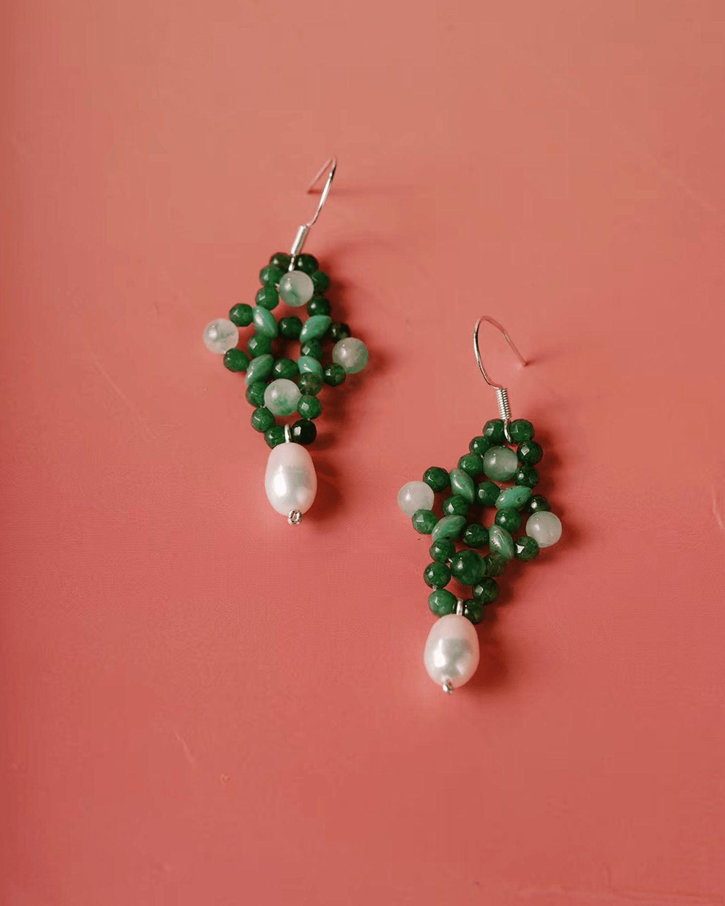 Flat lay of green aventurine knot earrings with hand-tied Chinese knot design, symbolizing unity and intention