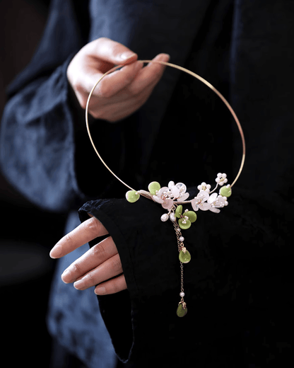 Flat lay of rose quartz choker with silver plum blossom pendant, showcasing delicate oriental design and gemstone clarity