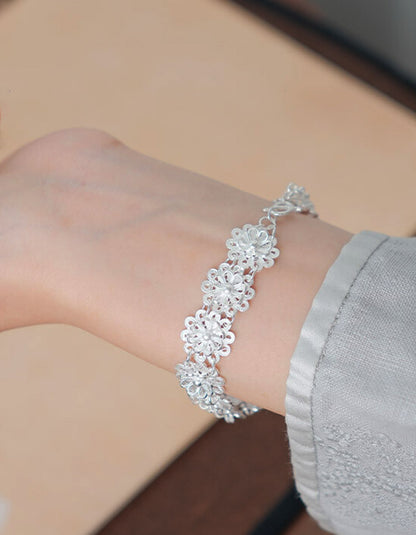Close-up of handcrafted double lotus filigree bracelet in 925 sterling silver with fine wirework