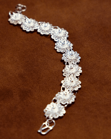 Close-up of handcrafted double lotus filigree bracelet in 925 sterling silver with fine wirework