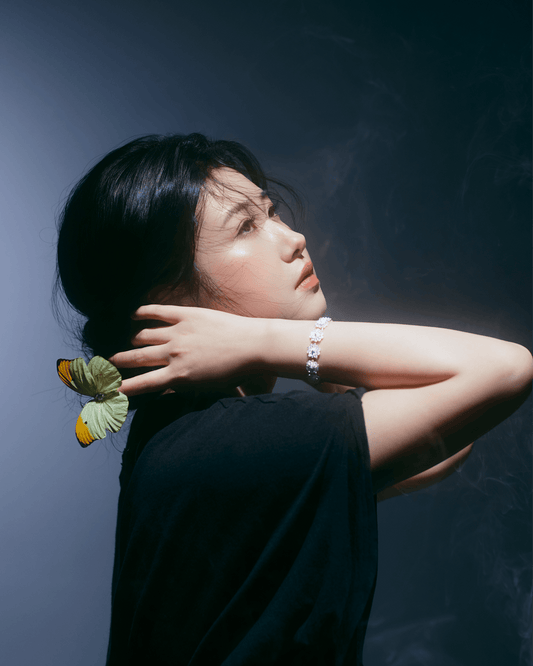 Model wearing Double Lotus Chinese Filigree Sterling Silver Bracelet, showcasing elegant layered lotus design