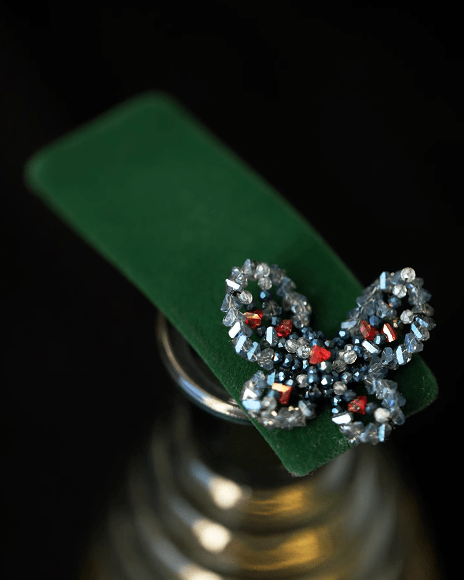 Flat lay of mulberry velvet hair clip with ombré shades of midnight blue, cinnabar red, and moonlight white, inspired by Dunhuang celestial dancers