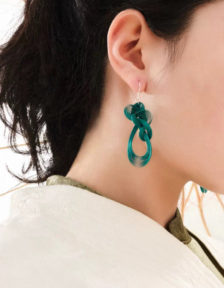 Handcrafted deep green bamboo-woven earrings with silver accents
