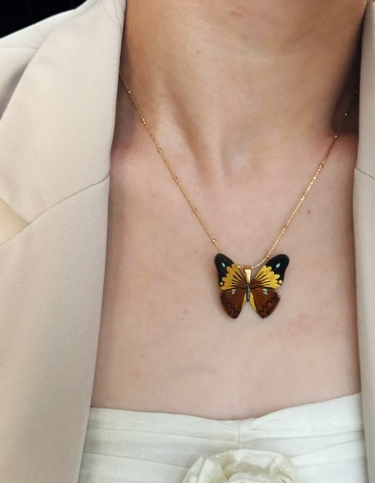 Elegant Model Wearing Black Gold Butterfly Lacquer Necklace with Dress