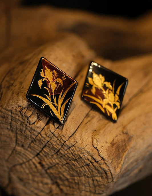 Detailed view showing brushwork and gold lacquer texture on the iris flower design.