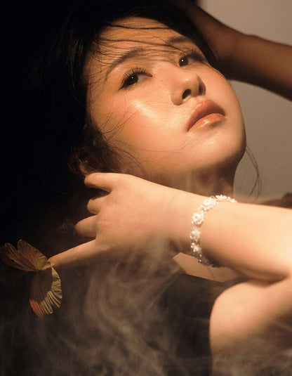 Asian model styling double-layer lotus filigree silver bracelet with traditional-inspired outfit
