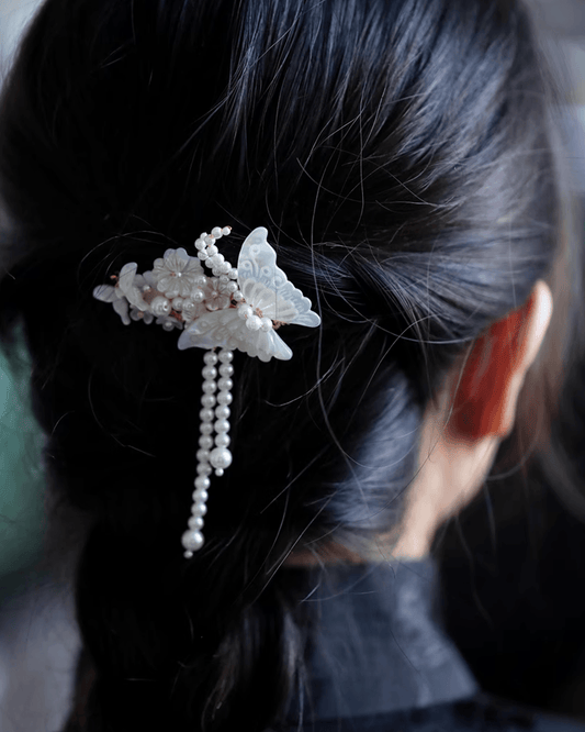 Model wearing iridescent butterfly hair clip styled in bridal updo, symbolizing eternal love and romance