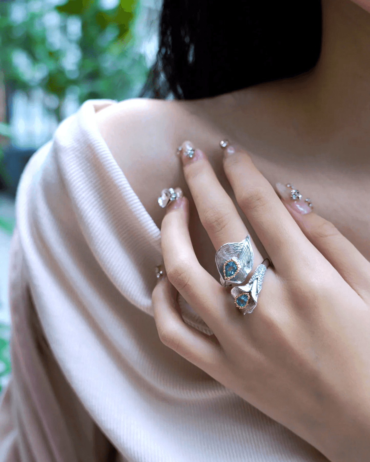 Close-up of ring worn on hand, capturing textured band and luminous gemstone, perfect for anniversary gift