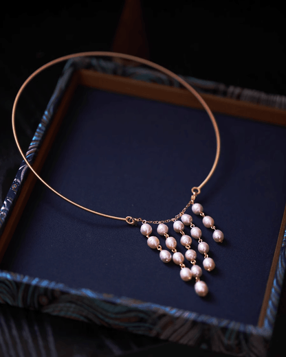 Wedding flat lay with pearl earrings, embroidered qipao fabric and red envelope, perfect for bridal heirloom styling