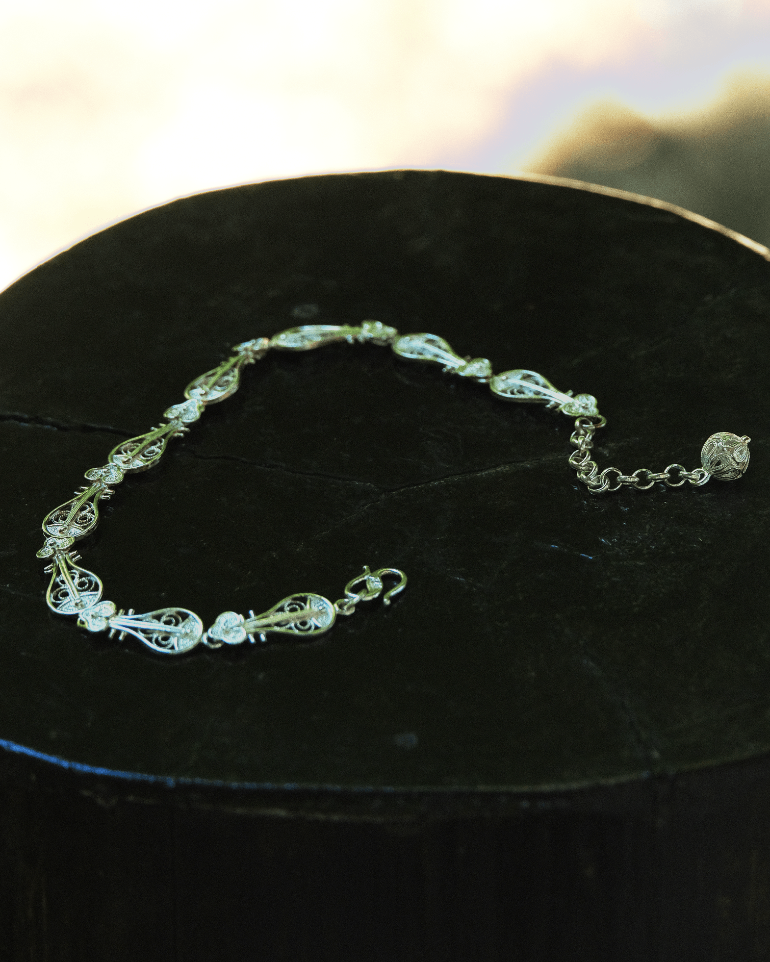 Close-up of handcrafted Pipa-shaped silver bracelet with fine Chinese filigree wirework