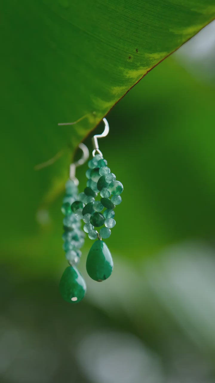 Close-up of aventurine knots swaying gently with head movement, reflecting natural harmony