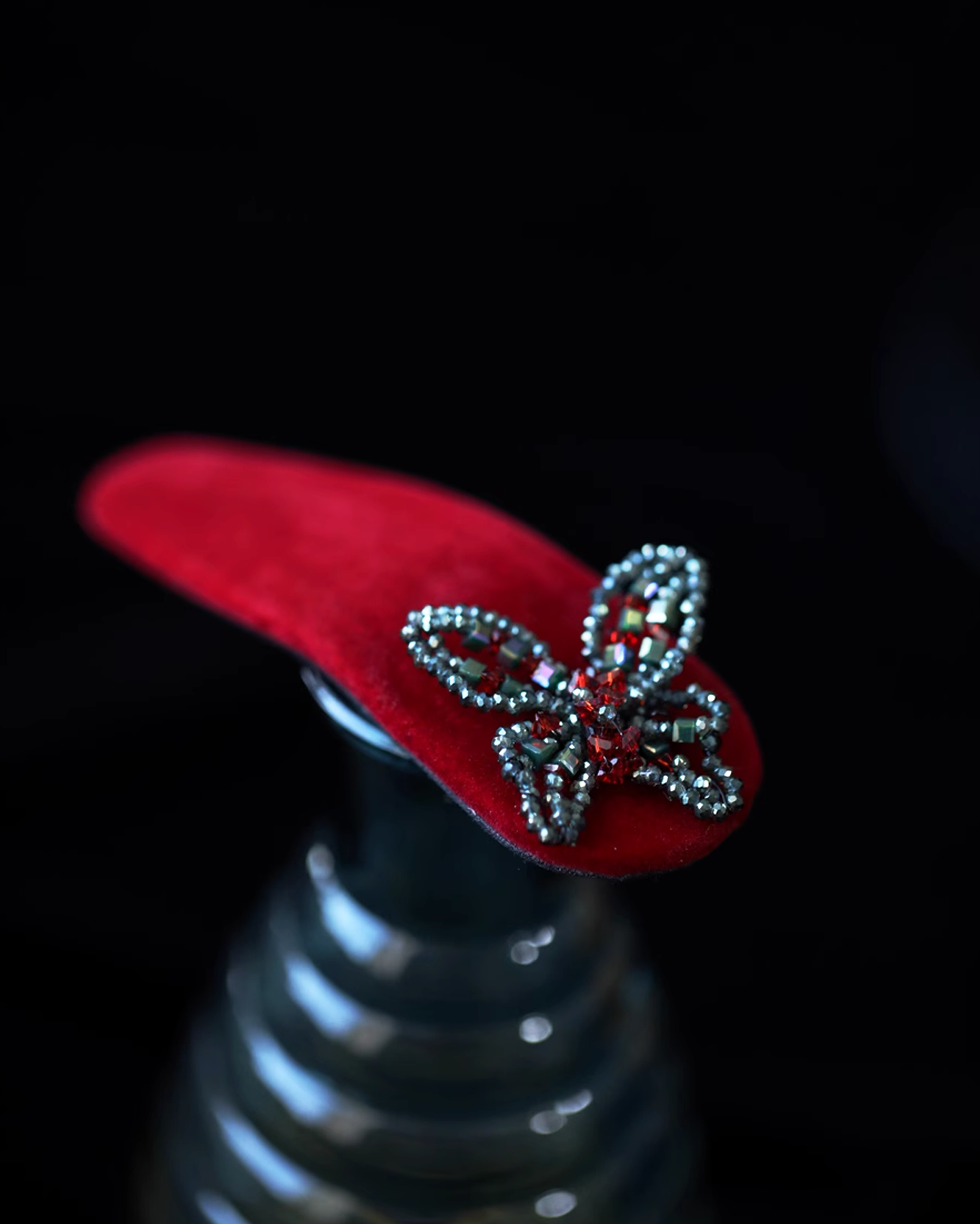 Close-up of velvet texture and crystal embellishments resembling morning dew on silk wings