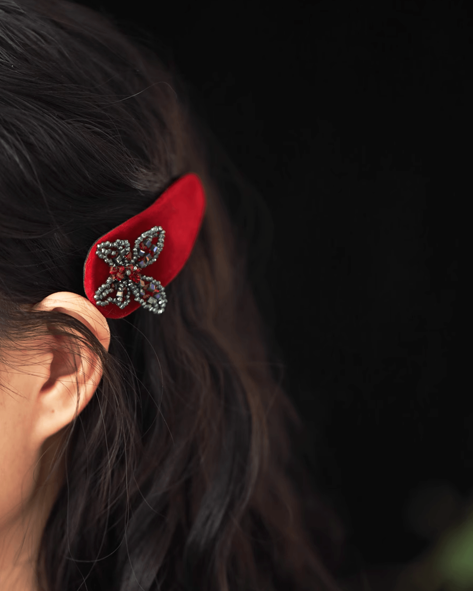 Side profile of modern updo enhanced with ombré velvet clip, shimmering crystals catching light