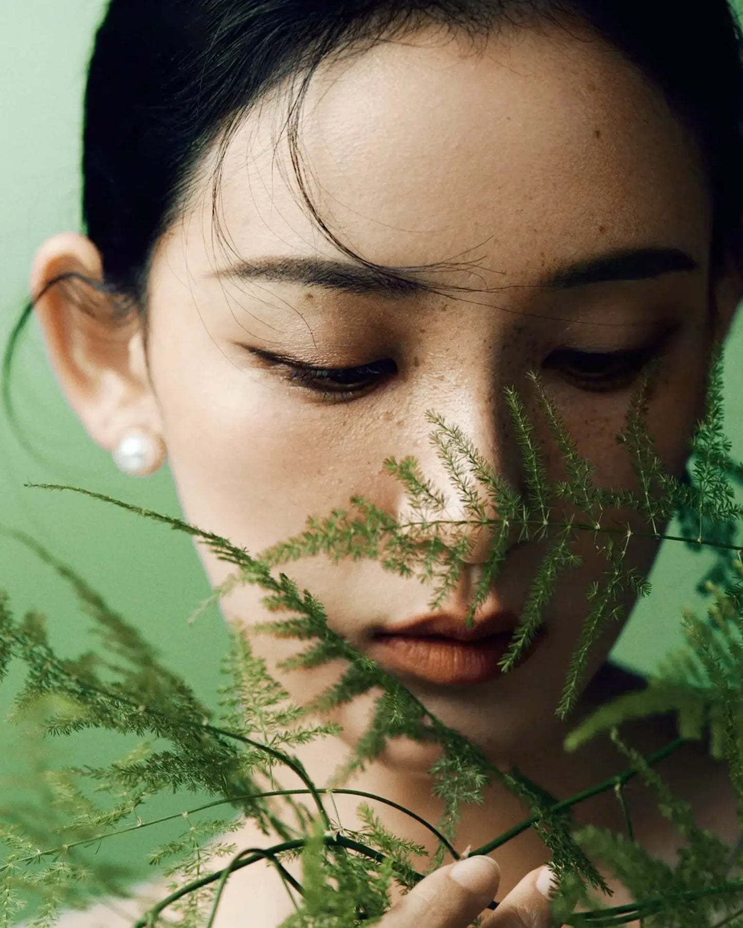 Model wearing 12mm pearl studs with soft silk blouse, reflecting timeless elegance and calm