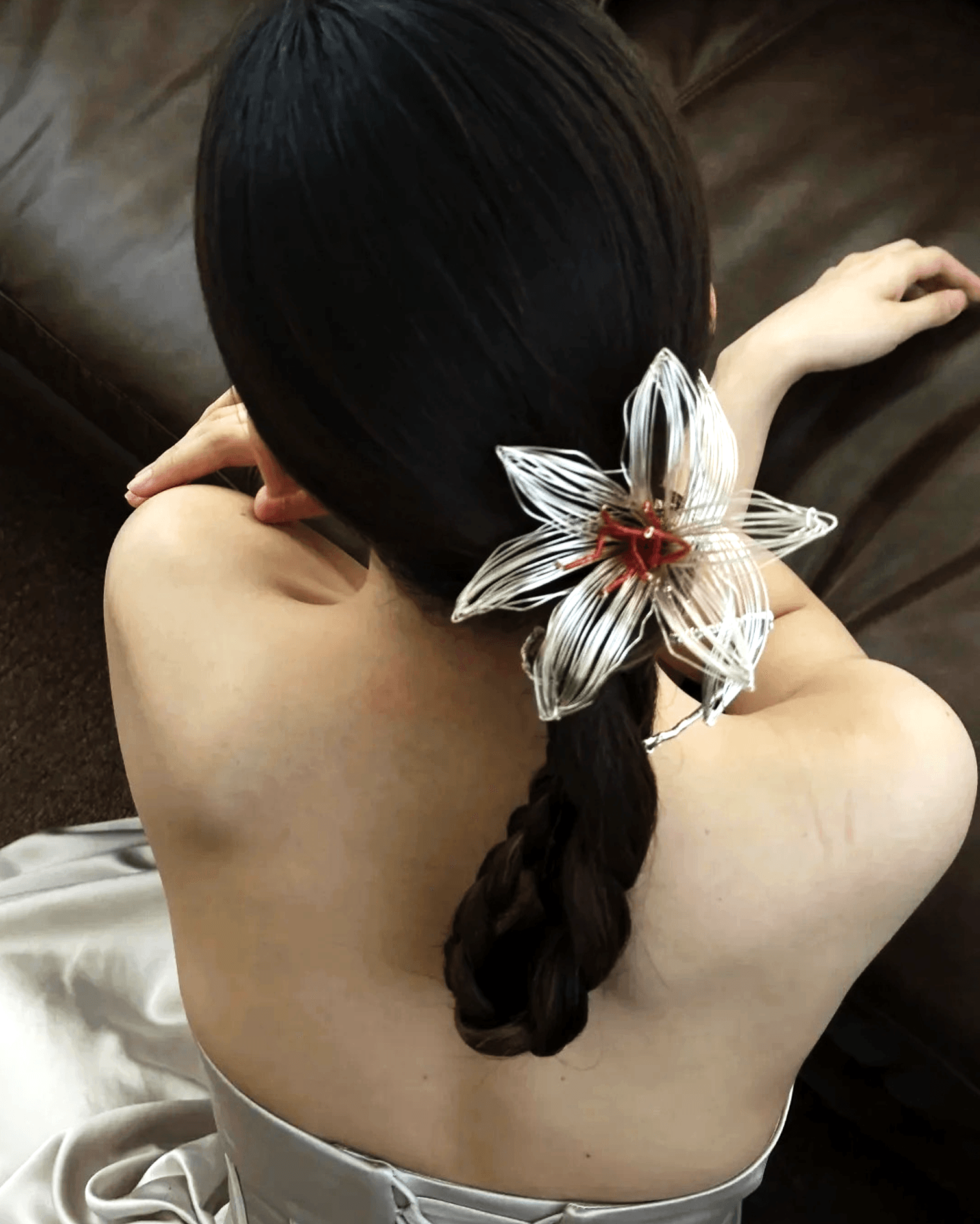 Flat lay of silver-plated wire bridal crown inspired by Song dynasty lily botanical sketches, delicate layered petal design