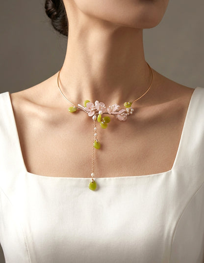 Hand-carved rose quartz plum blossom choker featuring soft blush tones. An elegant Chinese floral statement necklace for modern elegant styling.